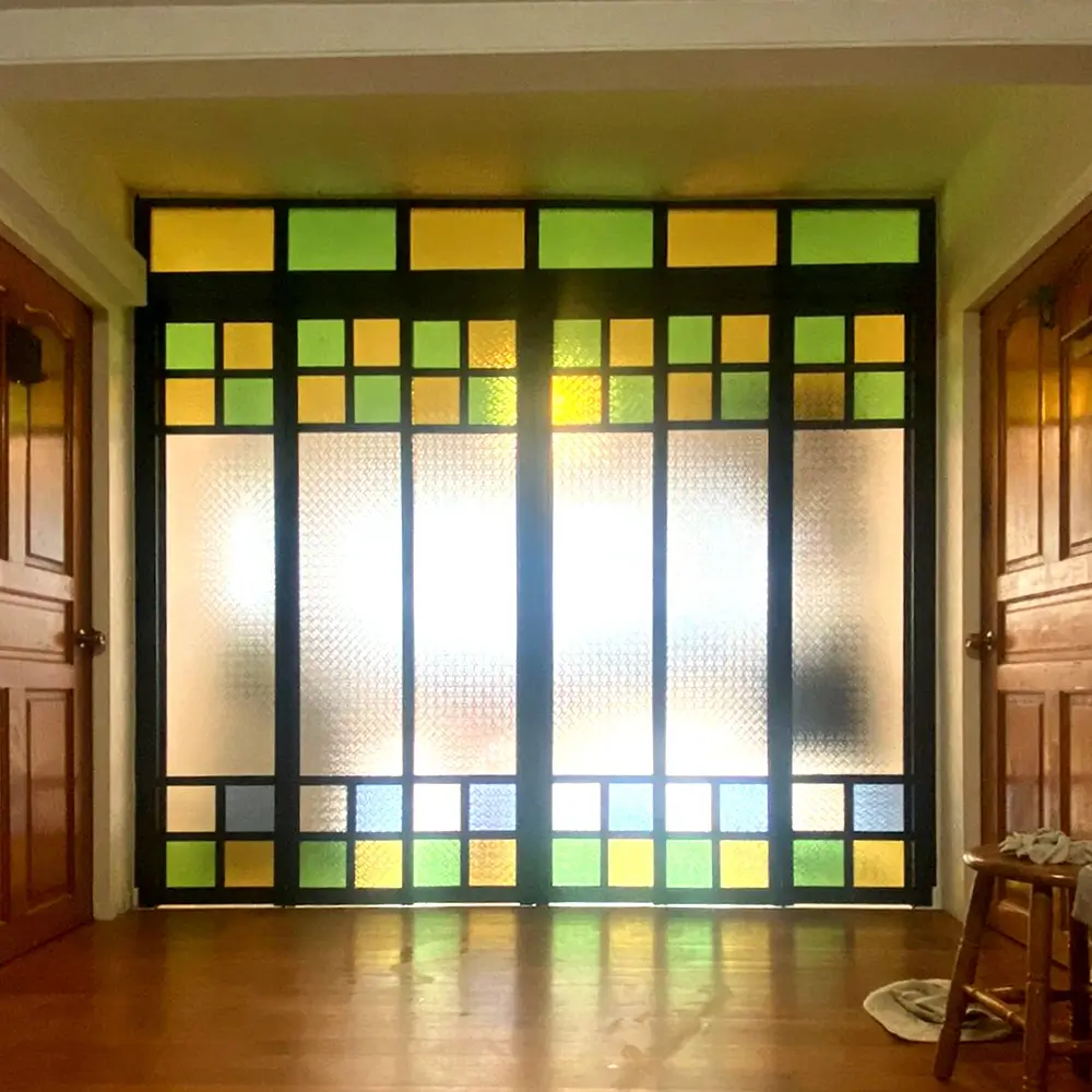 #10 Black Top Hung Aluminium Framed 6 Panel Divider with 2x 3Panel Folding Doors (VG8840) with Slide to Fold System and Classy Invisible VG Hinge in Custom Design with Panel A: Design Glass Peranakan-Inspired Glass featuring Blue, Green, Yellow, and Clear Floral Glass Panels and Box Up for Living Room